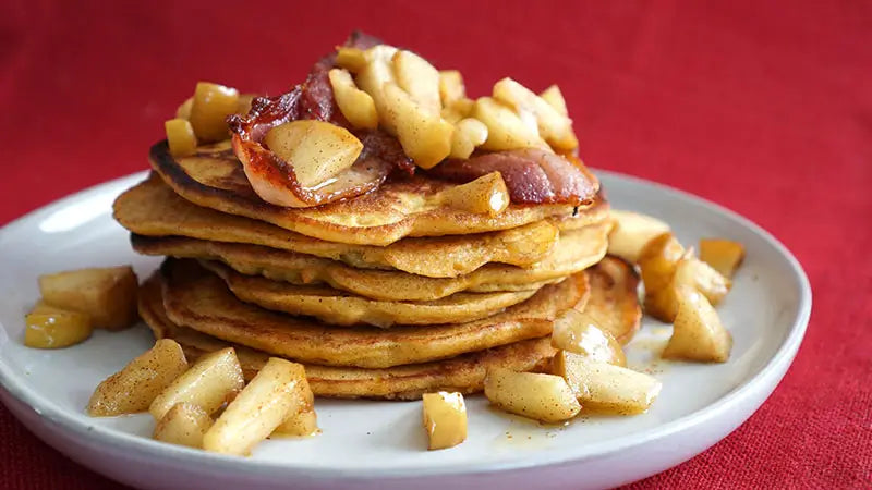 A stack of Garam Masala spiced pancakes cooked in ghee and topped with cooked apples