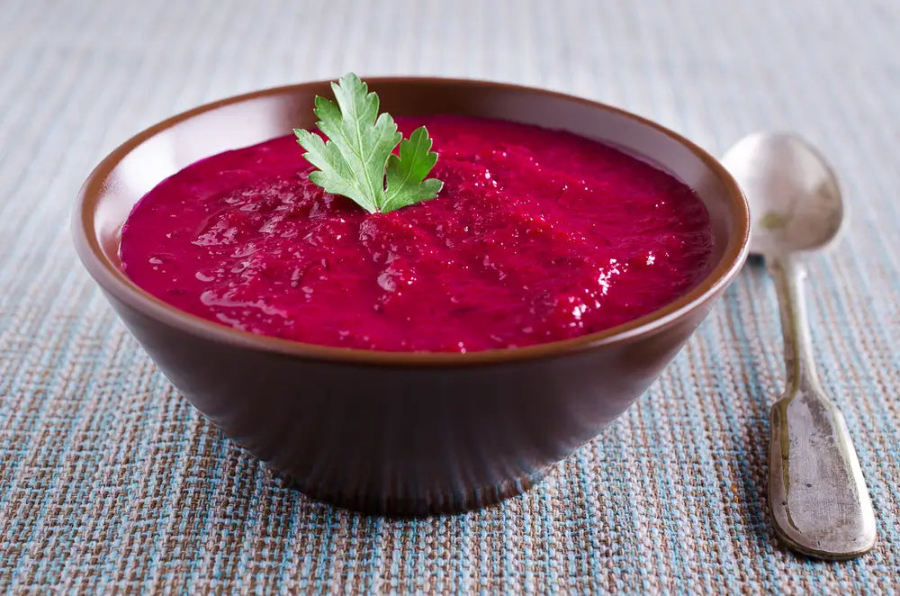 A bowl of roasted beet and carrot soup.