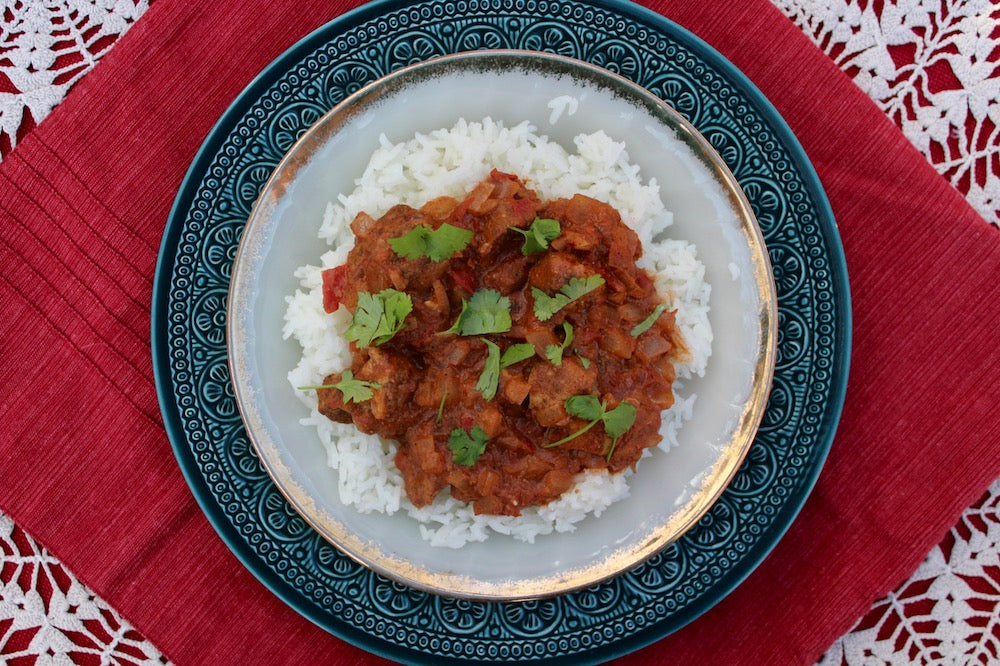 A plateful of chicken tikka masala on basmati rice.