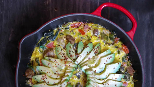 A birds eye view of a cast iron skillet with a frittata in it.