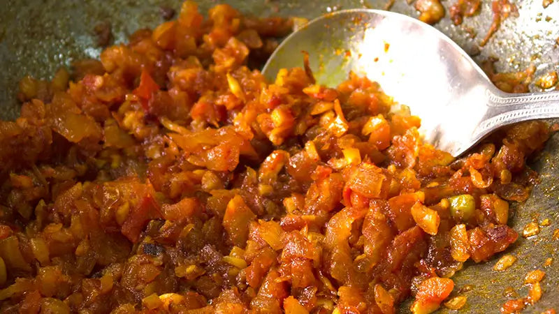 A skillet full of onion masala.