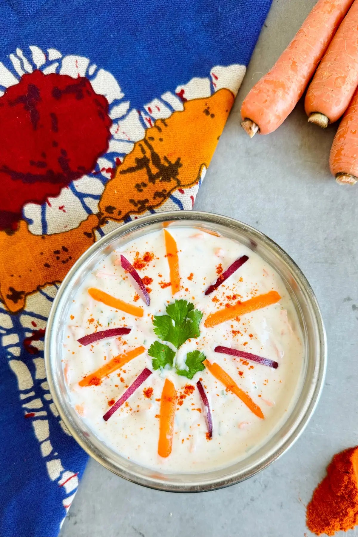 A bowl of easy carrot raita made with Pure Indian Foods organic spices.