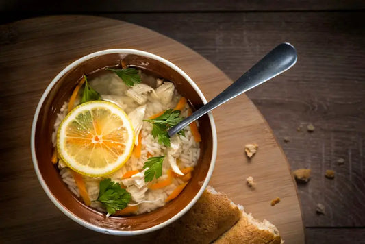 Birds eye view of a bowl of white pepper lemon soup.