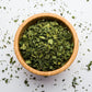 a small wooden bowl full of organic dried fenugreek leaves 